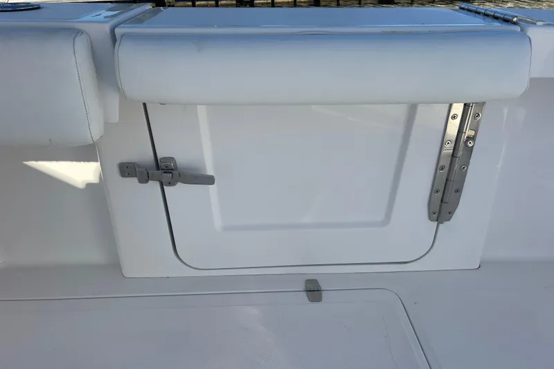 Slide: The Image of 2018 Southport 33 FE boat storage compartment with secure latch and hinge. - 25