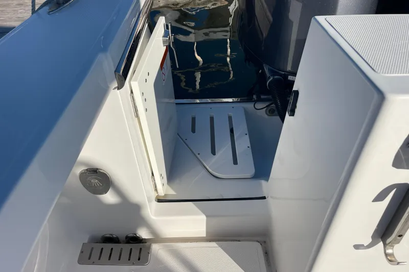 Slide: The Image of 2018 Southport 33 FE boat interior with open hatch and engine compartment. - 29