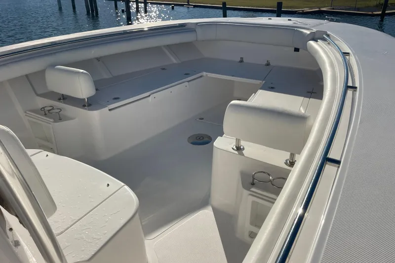 Slide: The Image of 2018 Southport 33 FE boat interior with white seating and cup holders. - 32