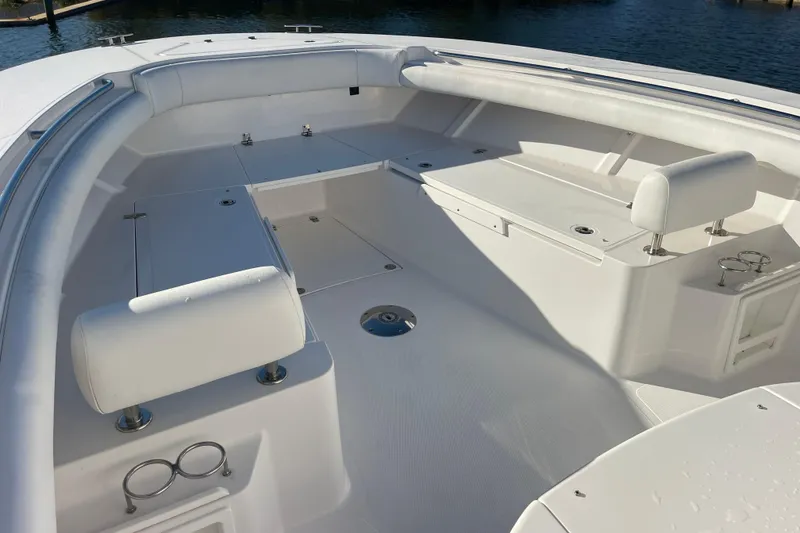 Slide: The Image of 2018 Southport 33 FE boat interior with white seating and cup holders. - 34