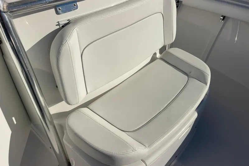 Slide: The Image of 2018 Southport 33 FE boat seat with white upholstery and stainless steel accents. - 37