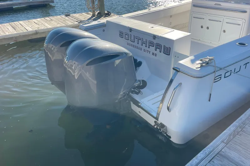 Slide: The Image of 2018 Southport 33 FE boat with dual outboard engines docked at marina. - 4