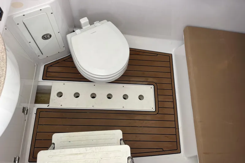 Slide: The Image of 2018 Southport 33 FE boat bathroom with wooden flooring and white toilet. - 41