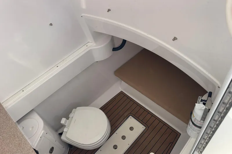 Slide: The Image of 2018 Southport 33 FE boat interior with toilet and wooden flooring. - 42