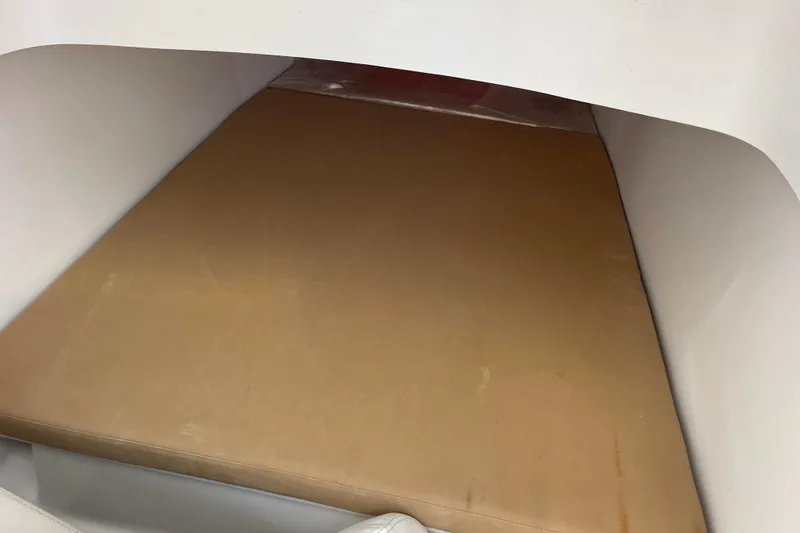 Slide: The Image of Interior cabin of 2018 Southport 33 FE boat with a tan cushion. - 43