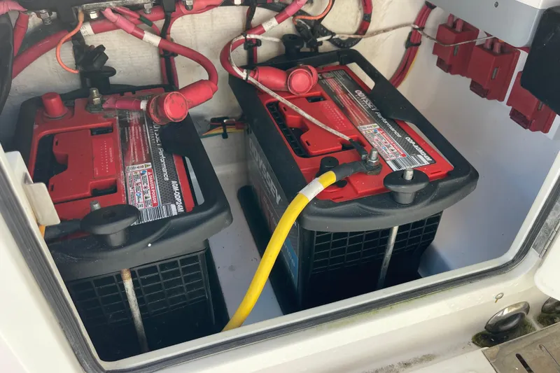Slide: The Image of Battery compartment of a 2018 Southport 33 FE boat with connected cables. - 47