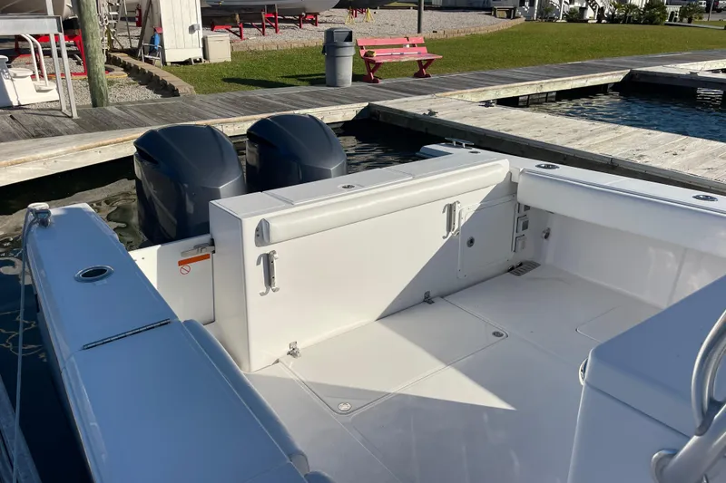 Slide: The Image of 2018 Southport 33 FE boat with dual outboard engines docked at a marina. - 6
