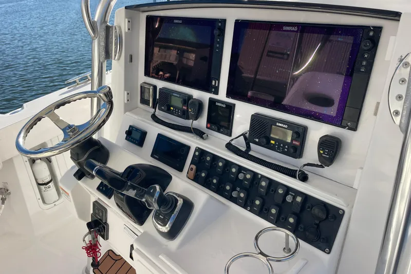 Slide: The Image of 2018 Southport 33 FE boat dashboard with dual Simrad displays and control panel. - 9