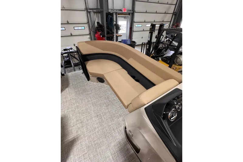 Slide: The Image of 2026 Lowe LS 170 boat interior with beige seating in a garage setting. - 11