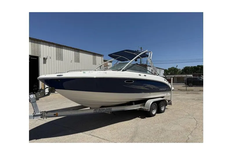 Slide: The Image of 2007 Chaparral 236 SSX boat on trailer, parked outside a warehouse. - 1