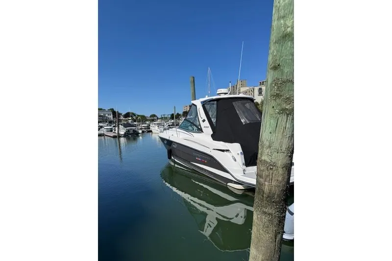 Slide: The Image of 2021 Monterey 335 Sport Yacht docked in a marina under clear blue skies. - 11