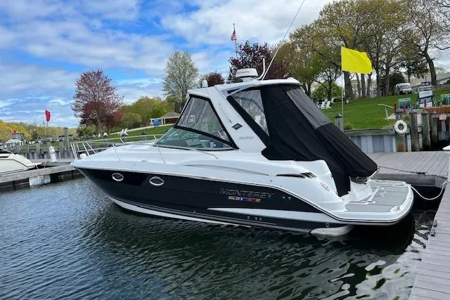 Slide: The Image of 2021 Monterey 335 Sport Yacht docked at a marina, featuring sleek design and modern amenities. - 12