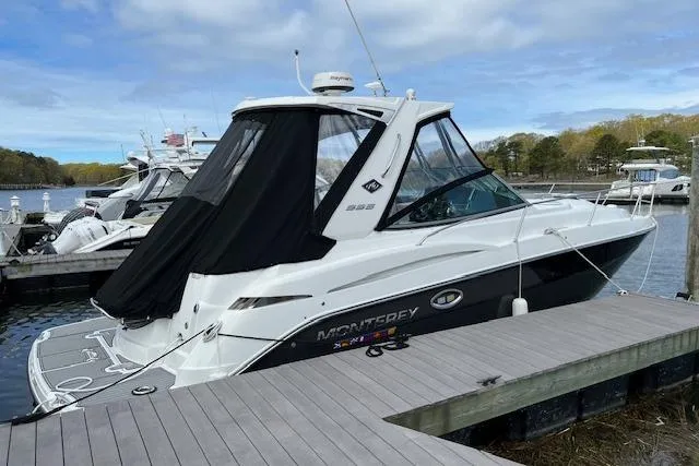 Slide: The Image of 2021 Monterey 335 Sport Yacht docked, featuring sleek design and black canopy. - 14
