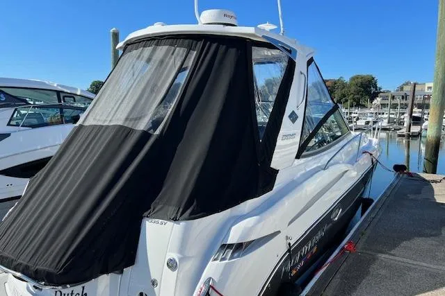 Slide: The Image of 2021 Monterey 335 Sport Yacht docked, featuring sleek design and black canopy. - 17