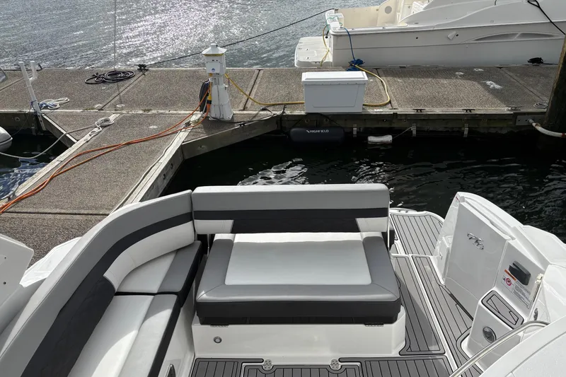 Slide: The Image of 2021 Monterey 335 Sport Yacht at dock, featuring sleek seating and modern design. - 23