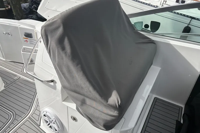 Slide: The Image of 2021 Monterey 335 Sport Yacht helm covered, featuring sleek deck design and stainless steel railings. - 24