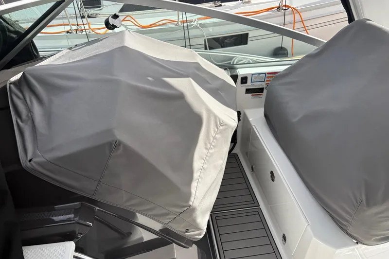 Slide: The Image of 2021 Monterey 335 Sport Yacht cockpit with protective covers, showcasing sleek design and modern features. - 25