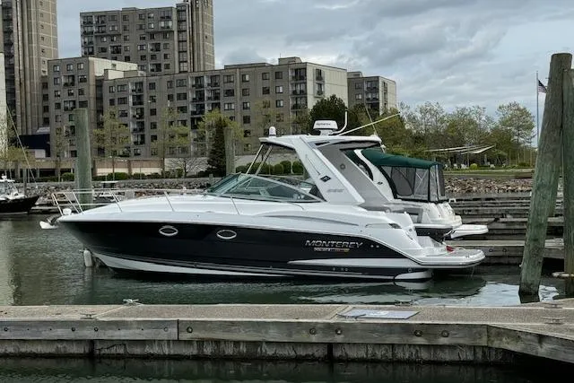 Slide: The Image of 2021 Monterey 335 Sport Yacht docked in urban marina with buildings in background. - 5