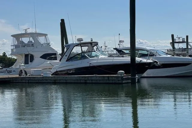 Slide: The Image of 2021 Monterey 335 Sport Yacht docked at marina, surrounded by other boats. - 7