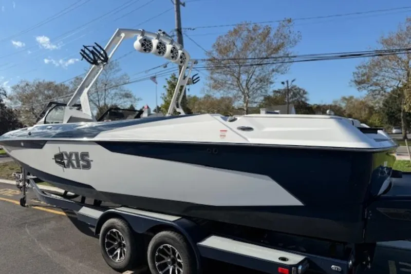Slide: The Image of 2022 Axis A24 boat on trailer, featuring sleek design and modern wakeboard tower. - 3