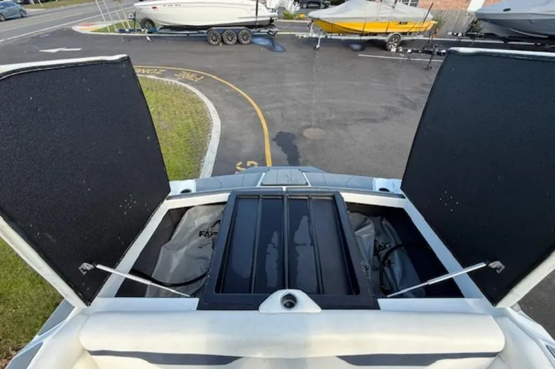 Slide: The Image of 2022 Axis A24 boat storage compartments open, showcasing interior space. - 8