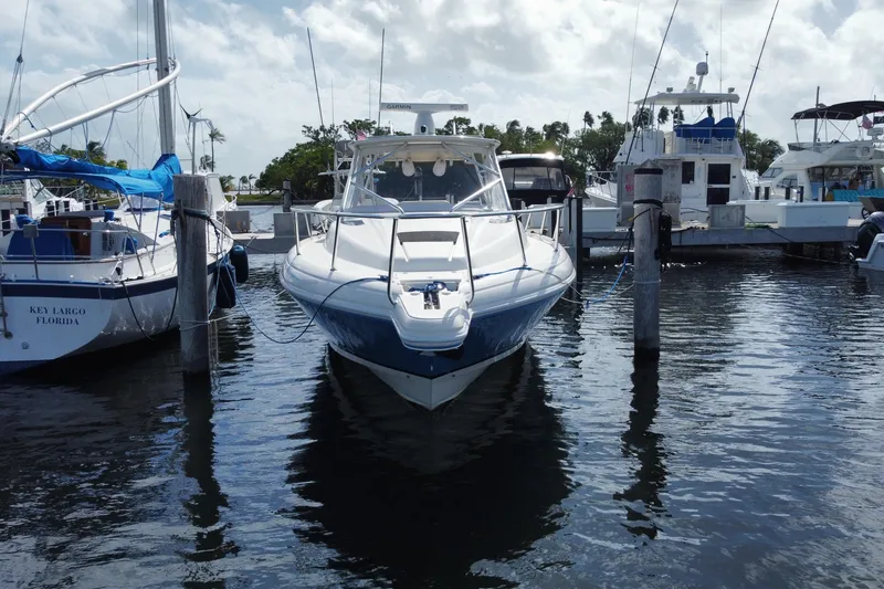 Slide: The Image of 2006 Intrepid 377 boat docked at marina, surrounded by other vessels. - 1