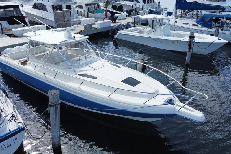 Slide: The Image of 2006 Intrepid 377 boat docked in marina, surrounded by other vessels. - 10