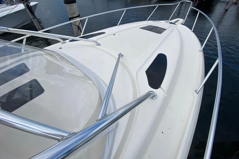 Slide: The Image of 2006 Intrepid 377 boat deck with stainless steel railings, docked at marina. - 13