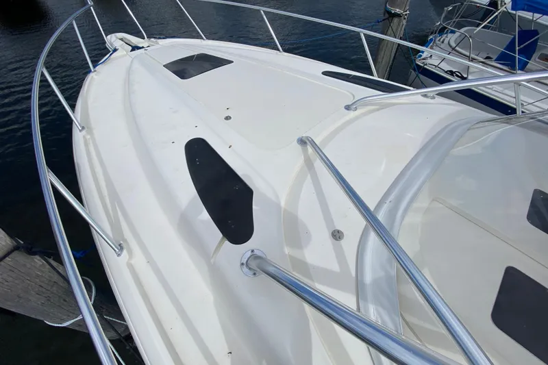 Slide: The Image of 2006 Intrepid 377 boat deck with stainless steel railings, docked at marina. - 14