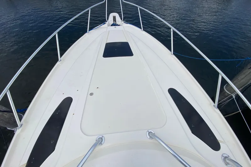 Slide: The Image of Bow view of a 2006 Intrepid 377 boat docked on calm water. - 15