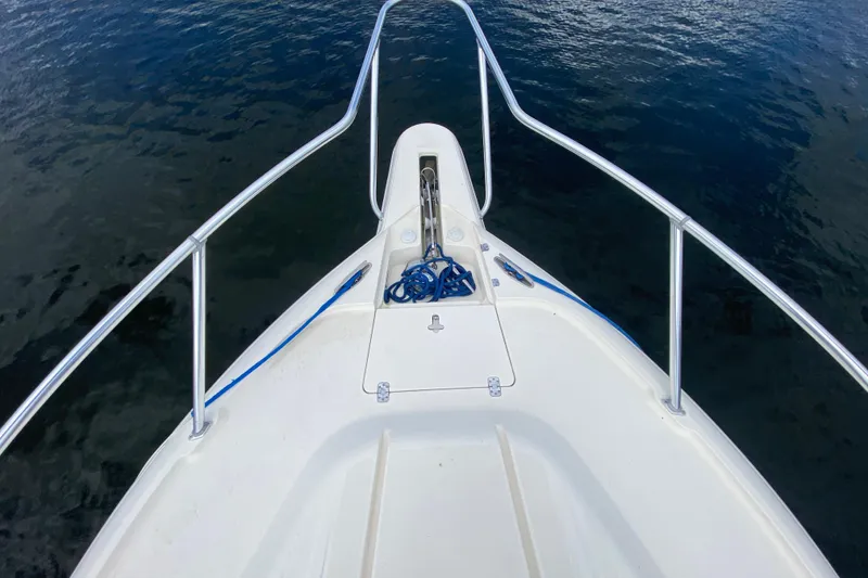 Slide: The Image of Bow view of 2006 Intrepid 377 boat with railing and anchor rope on calm water. - 16