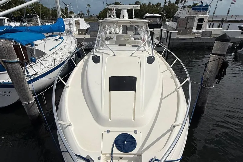 Slide: The Image of 2006 Intrepid 377 boat docked at marina, surrounded by other vessels. - 19