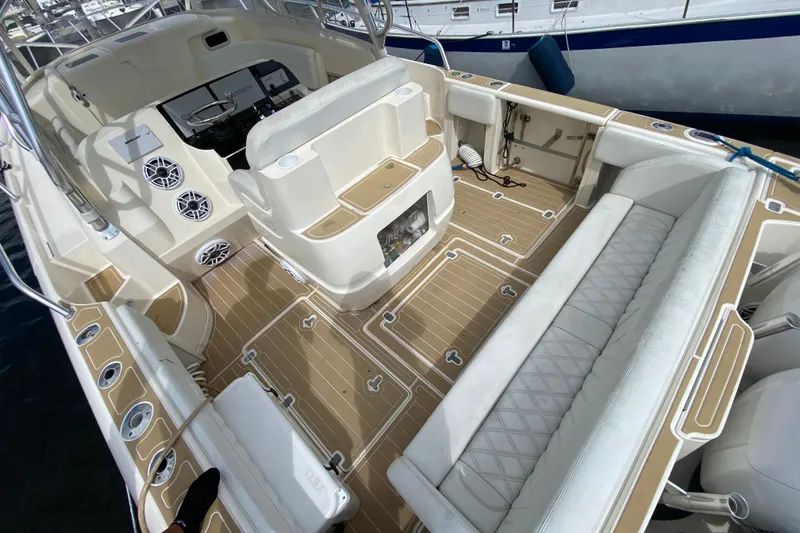 Slide: The Image of 2006 Intrepid 377 boat interior with beige seating and modern dashboard. - 20