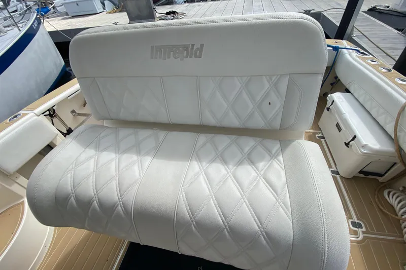 Slide: The Image of White leather seating on a 2006 Intrepid 377 boat, featuring diamond stitching. - 31