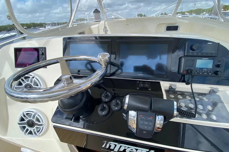 Slide: The Image of Helm of 2006 Intrepid 377 boat with modern navigation equipment and controls. - 32