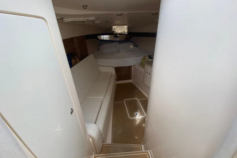Slide: The Image of Interior cabin of a 2006 Intrepid 377 boat with bed and seating area. - 35