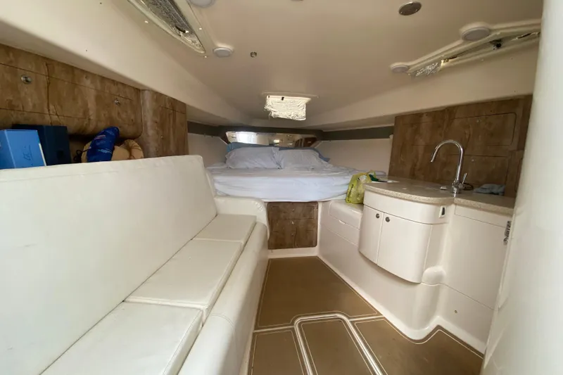 Slide: The Image of Interior of a 2006 Intrepid 377 boat with bed, seating, and kitchenette. - 36