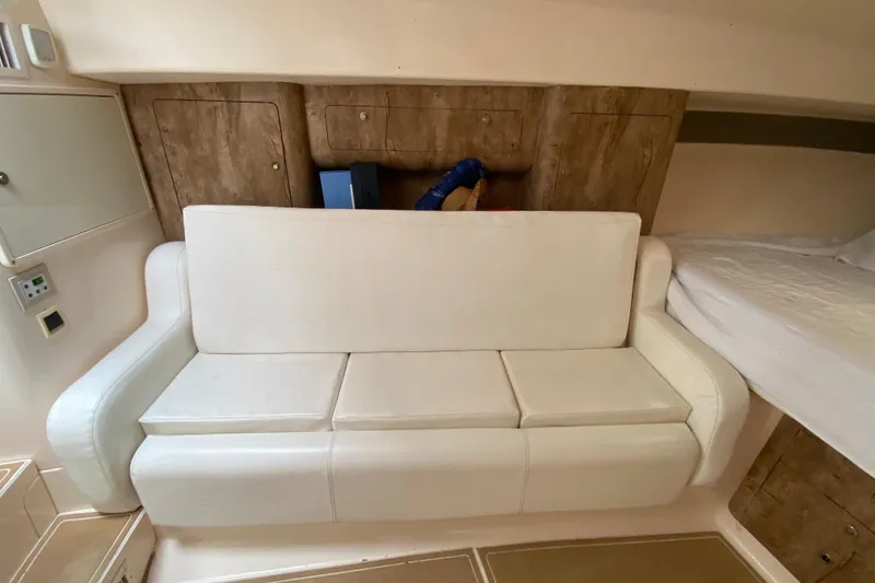 Slide: The Image of Interior of a 2006 Intrepid 377 boat with white seating and wooden accents. - 37