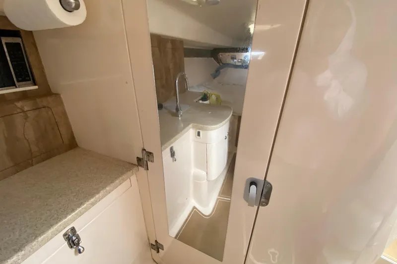 Slide: The Image of 2006 Intrepid 377 boat interior with compact bathroom and sink. - 39