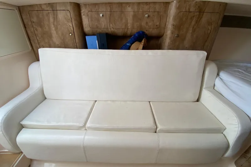 Slide: The Image of White leather sofa in 2006 Intrepid 377 boat interior with wooden cabinets. - 42