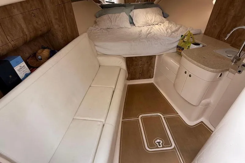 Slide: The Image of Interior of a 2006 Intrepid 377 boat with bed, sofa, and kitchenette. - 43