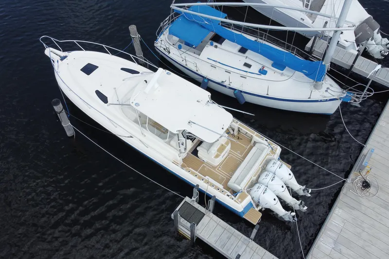 Slide: The Image of Aerial view of a 2006 Intrepid 377 boat docked beside a sailboat. - 46
