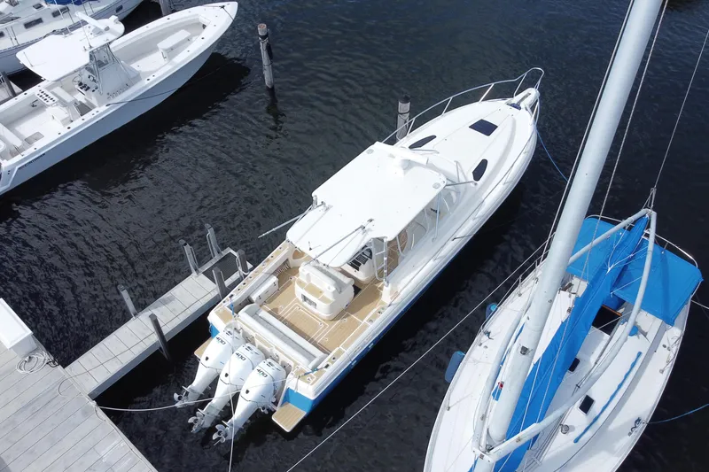 Slide: The Image of Aerial view of 2006 Intrepid 377 boat docked with triple outboard engines. - 47