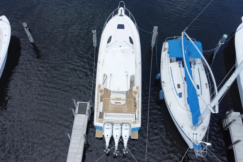 Slide: The Image of Aerial view of a 2006 Intrepid 377 boat docked between two other boats. - 49