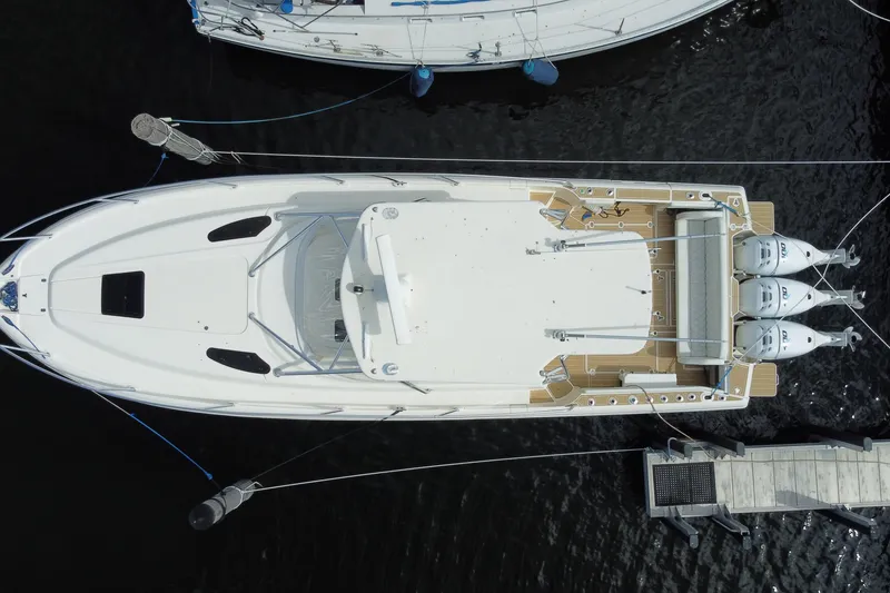 Slide: The Image of Aerial view of 2006 Intrepid 377 boat docked with triple outboard engines. - 54