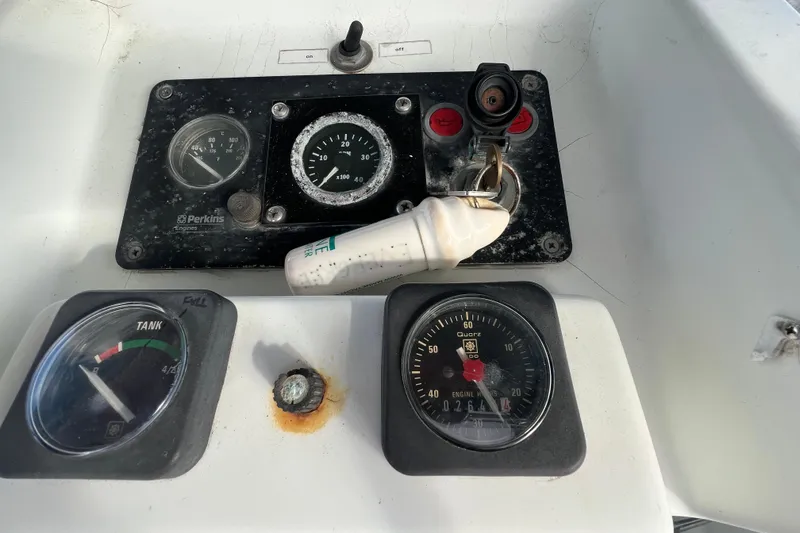 Slide: The Image of Control panel of a 1994 Beneteau Oceanis 351 sailboat with gauges and key. - 12