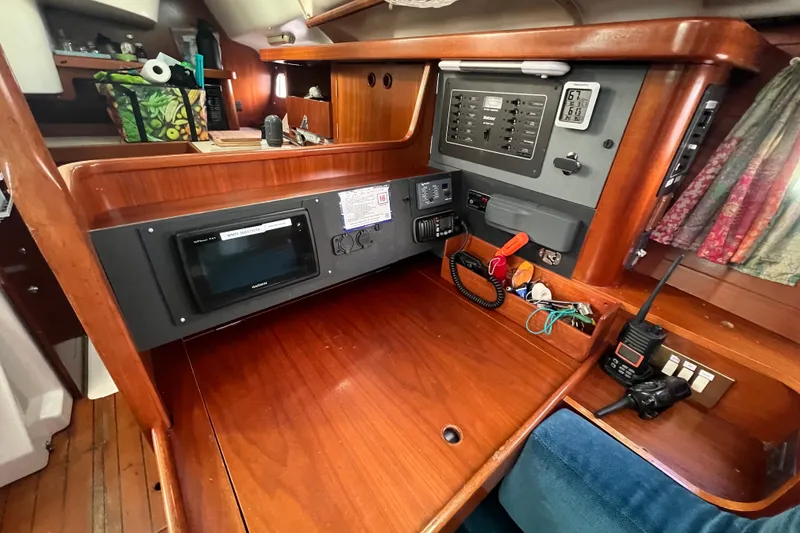 Slide: The Image of Navigation station of a 1994 Beneteau Oceanis 351 sailboat with control panel and radio equipment. - 15