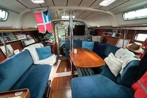 Slide: The Image of Interior of 1994 Beneteau Oceanis 351 sailboat with cozy seating and wooden table. - 20