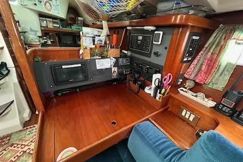 Slide: The Image of 1994 Beneteau Oceanis 351 yacht interior with navigation station and wooden cabinetry. - 24