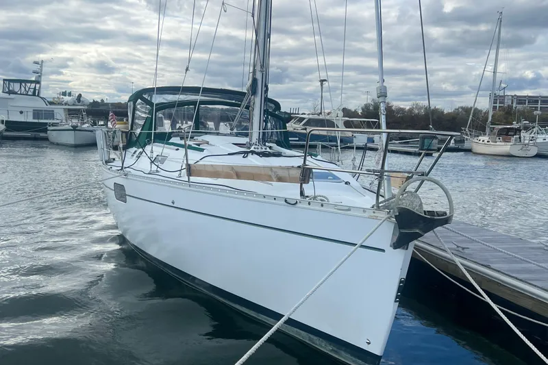 Slide: The Image of 1994 Beneteau Oceanis 351 sailboat docked in a marina under cloudy skies. - 3